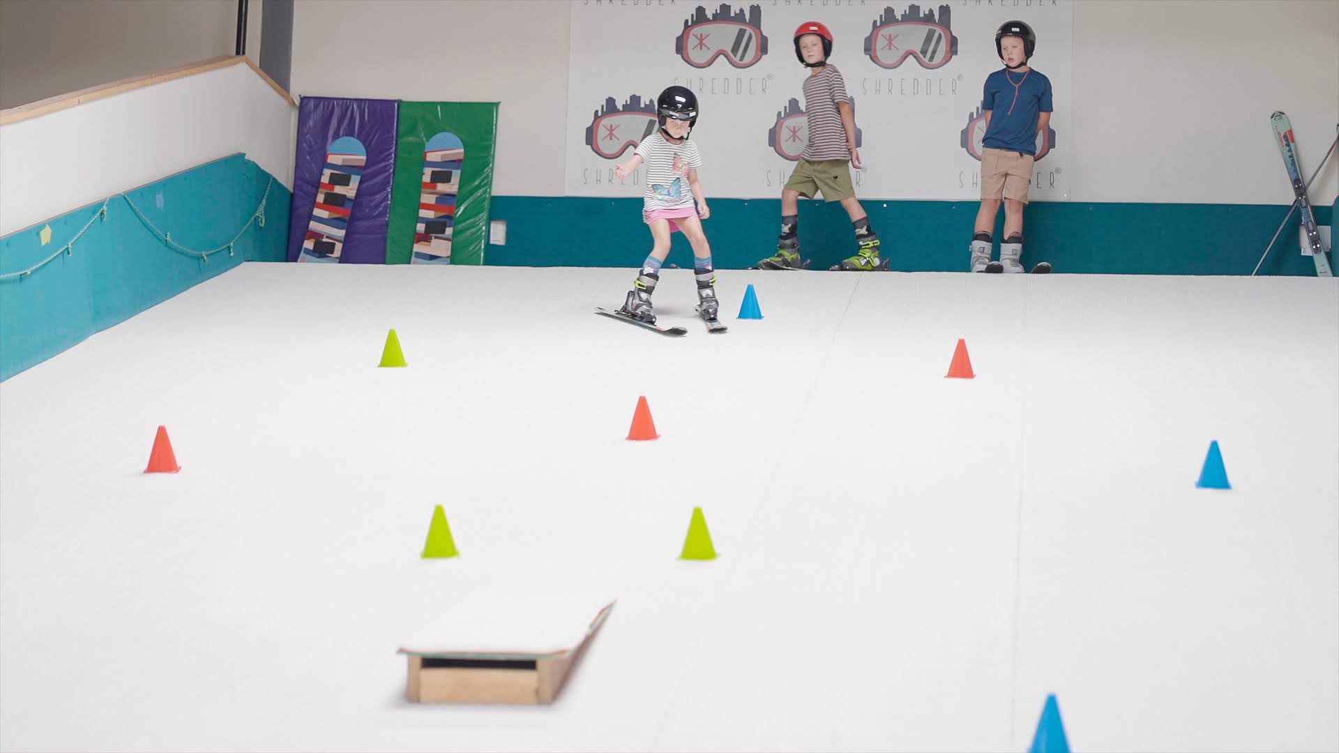 Child carving a turn during a Shredder training session