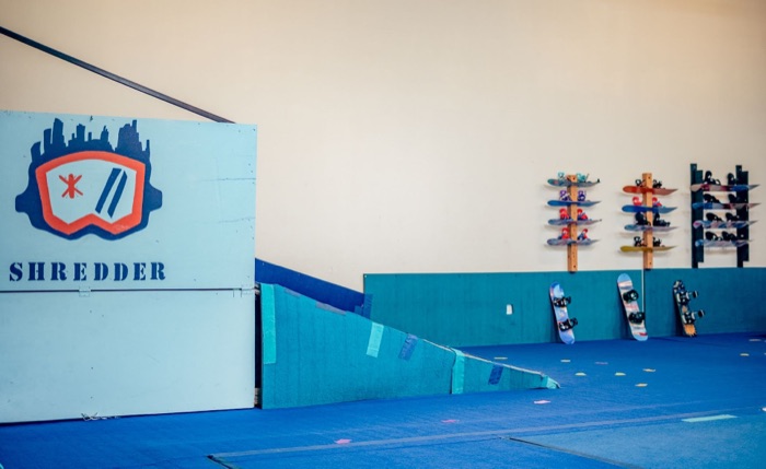 Shredder indoor slope with snowboards and ski equipment